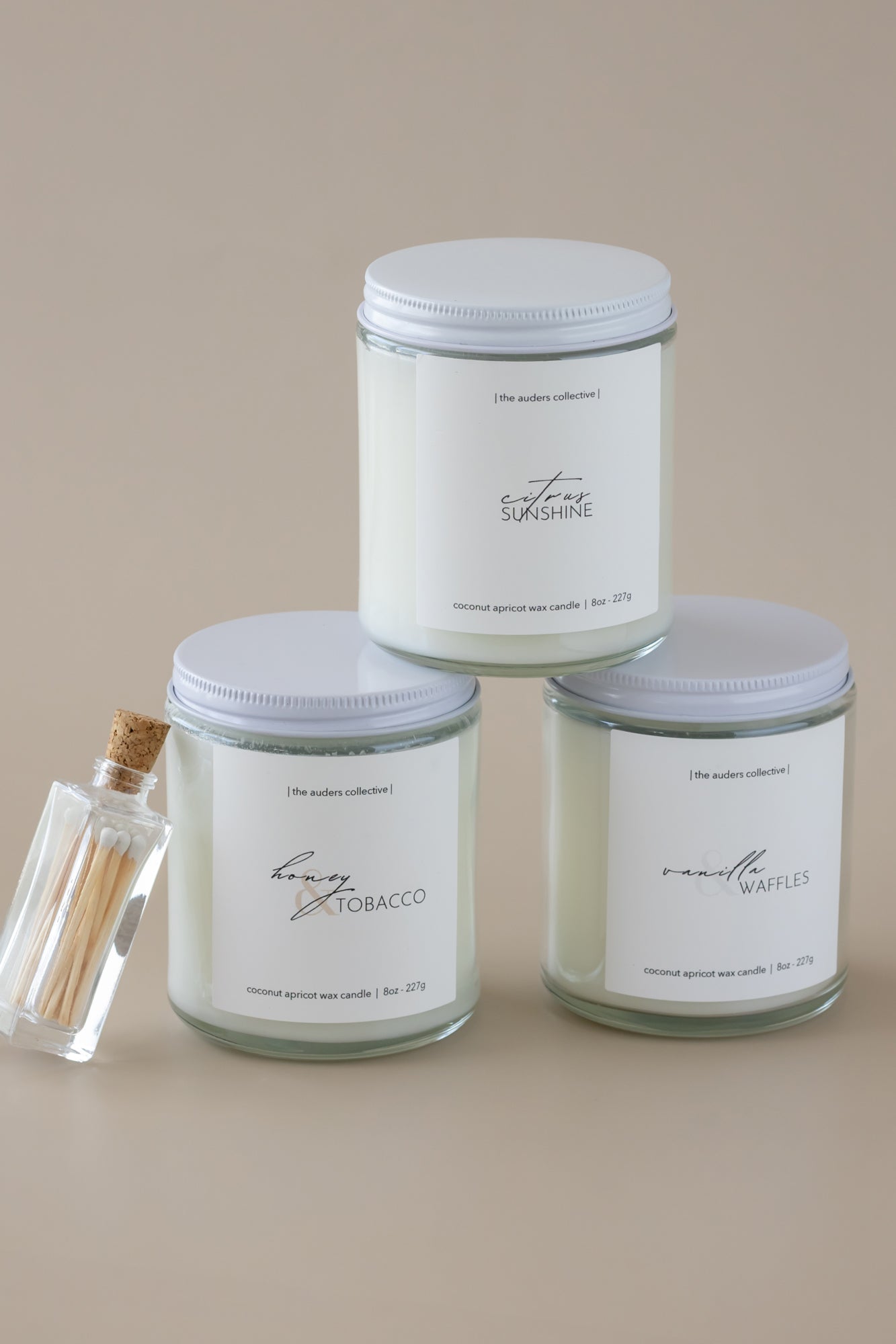 Three white candles with different scents. Honey and tobacco, vanilla and waffles and citrus Sunshine.