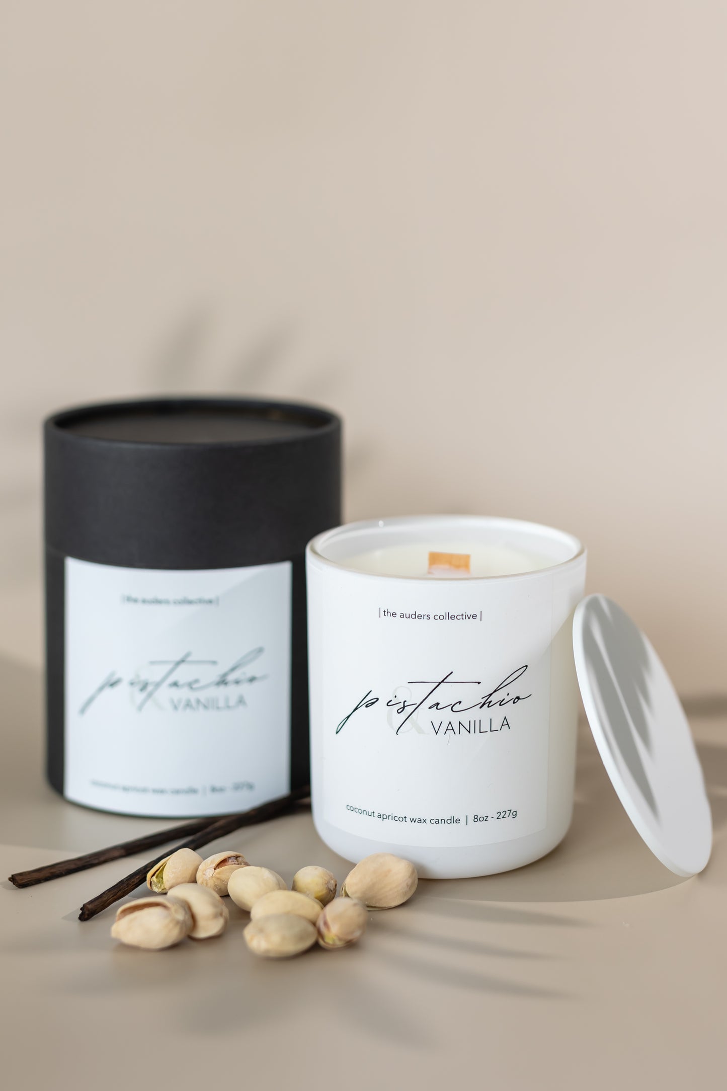 Pistachio & Vanilla scented candle in a white glass jar and black packaging tube with soft lighting, perfect for home décor and relaxation