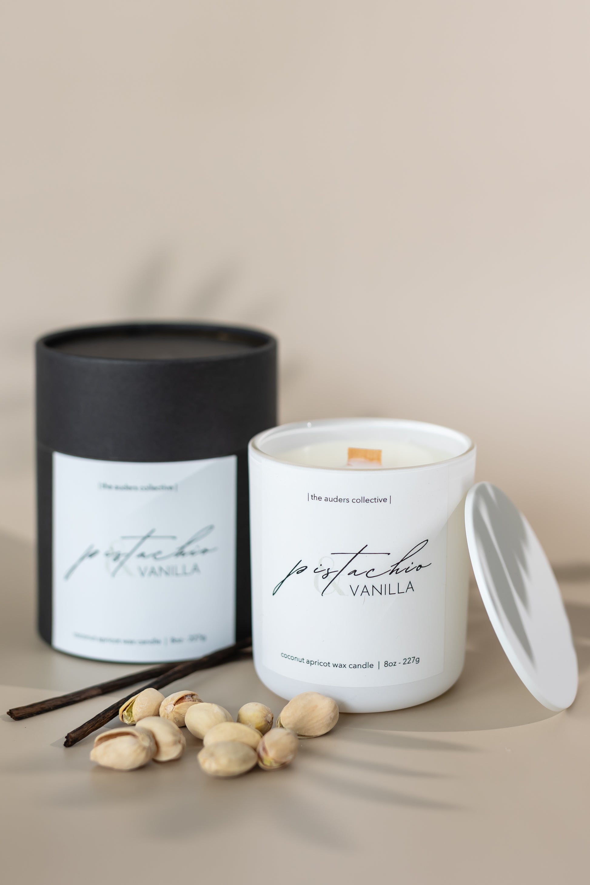 Pistachio & Vanilla scented candle in a white glass jar and black packaging tube with soft lighting, perfect for home décor and relaxation